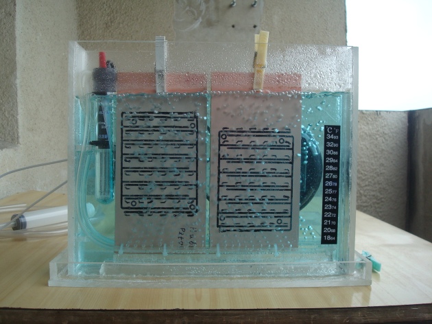 Two PCBs in an acid bath
